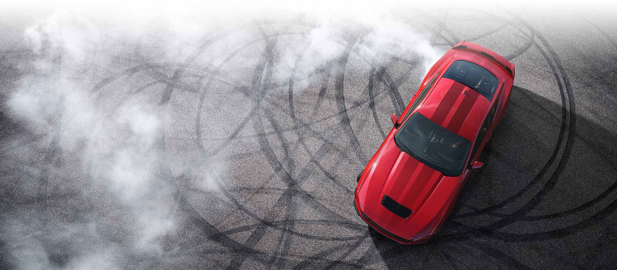 Overhead view of a 2024 Ford Mustang® model with tire tracks on pavement | Benton Ford in Benton KY